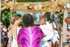 Bride and groom exchange vows at the altar as the guests watch