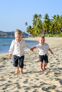 The newly married couple's sons stroll hand in hand by the beach
