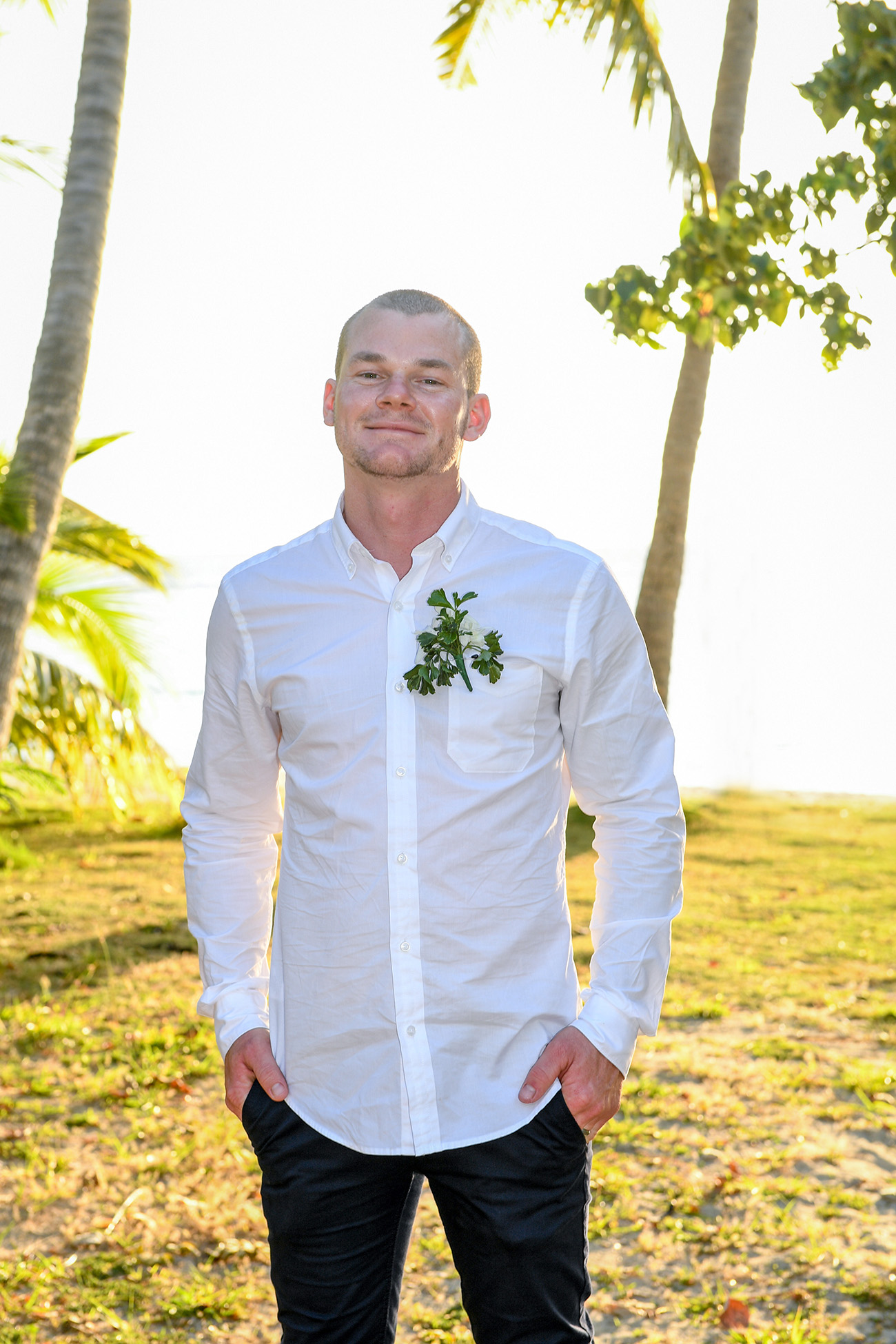 A happy groom smiles in the tropical paradise at the Plantation Island Resort Fiji