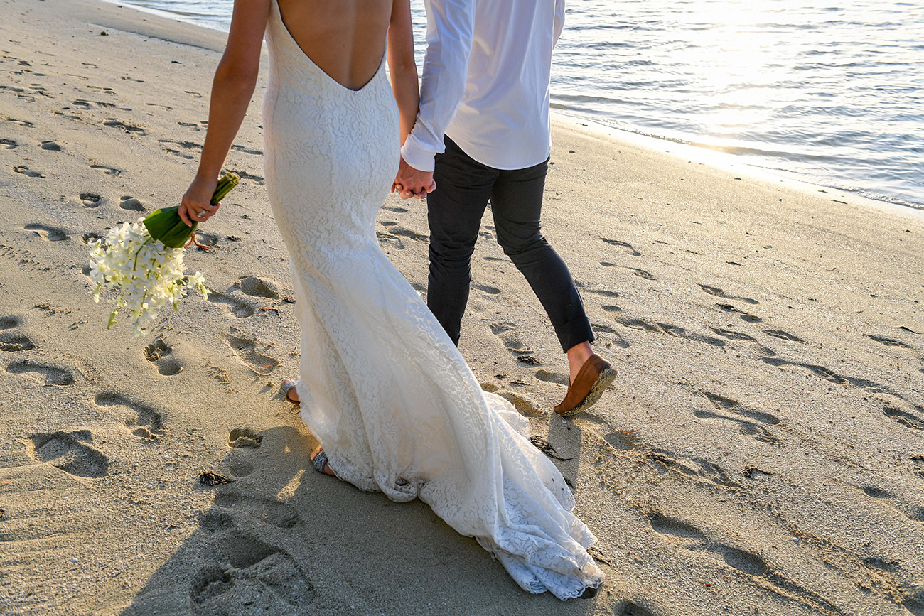 Bride's lace train on the sand in Plantation Island Resort Fiji