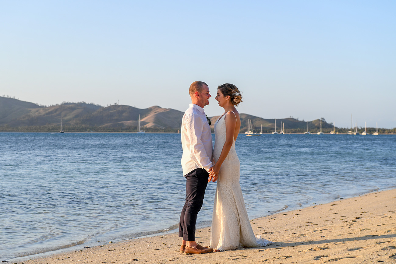 Newly married couple has a moment by the ocean