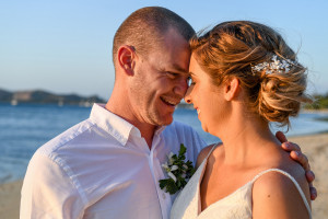 Bride and groom share a moment by the sea