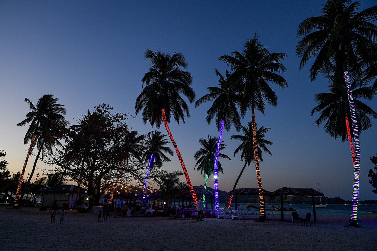 Colourful palm trees at outdoor night reception in Fiji Plantation Island Resort