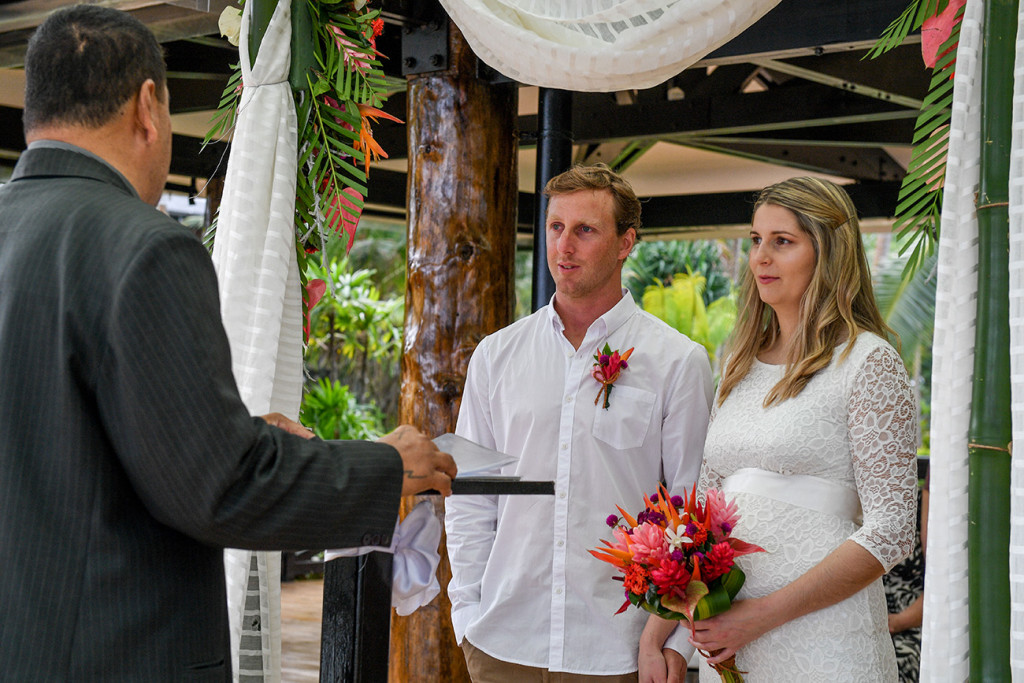 Bride and groom looking at the celebrant for their elopement in Fiji
