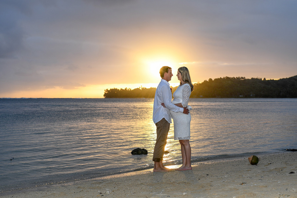 The bride and groom at sunset on the Fiji beach looking at eachothers