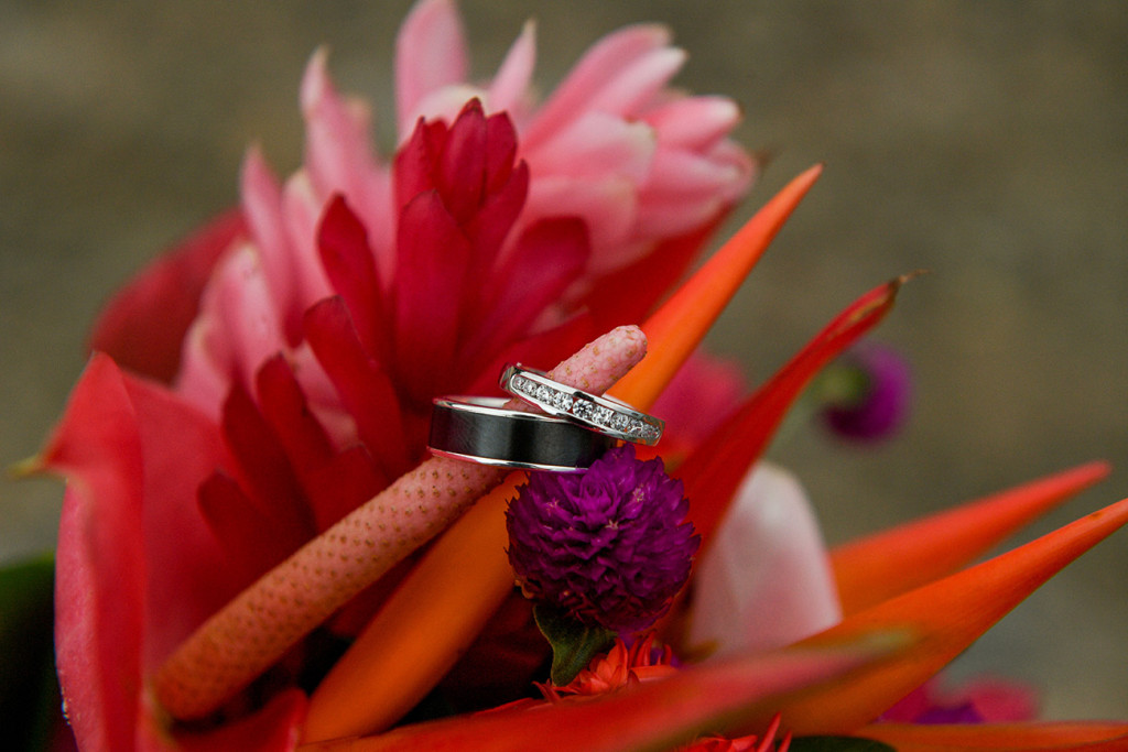 Close up on the wedding ring with the tropical flowers from the bouquet