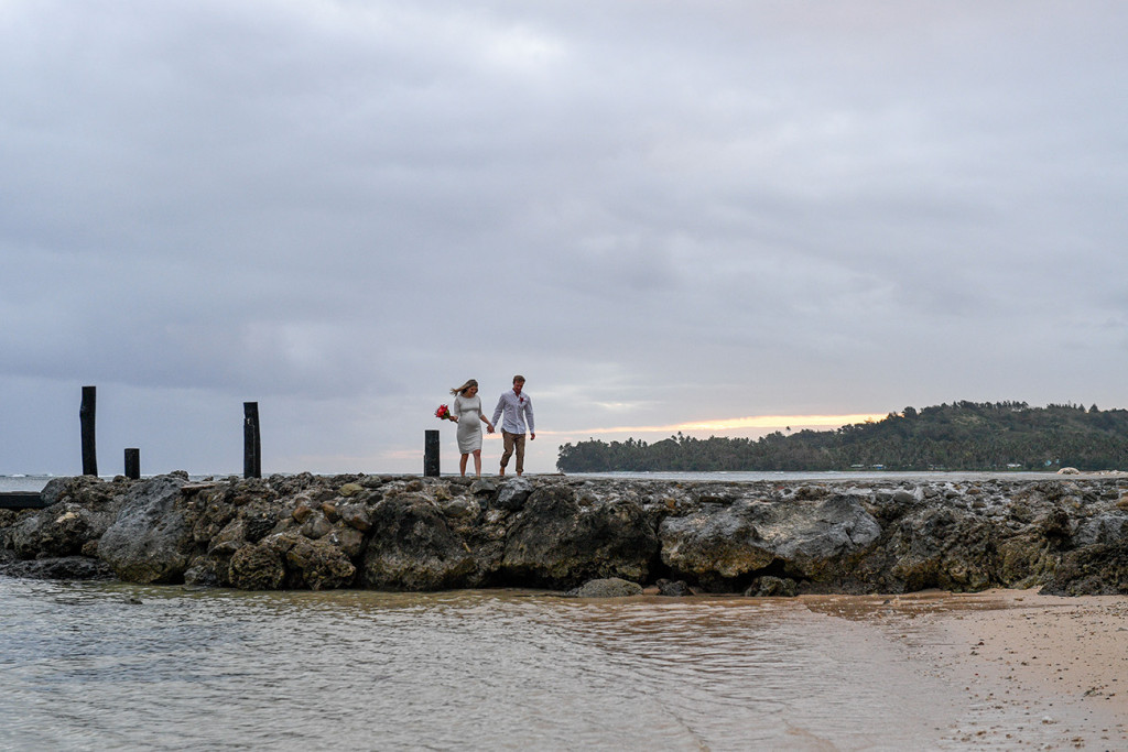 Bride and broom are walking along the jetty at the Warwick
