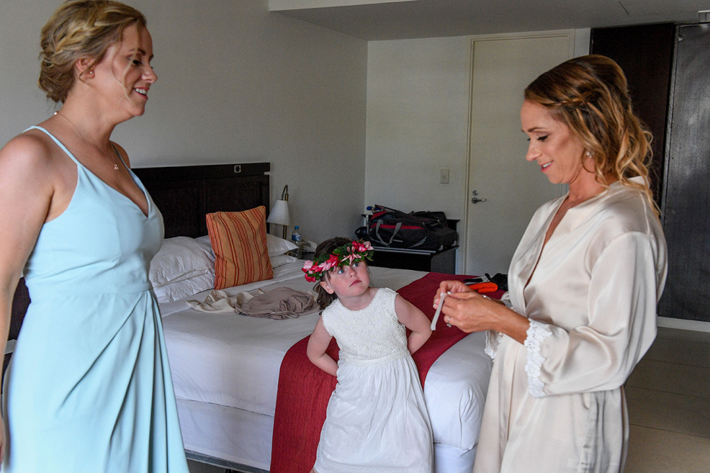 Bridesmaid, flower girl and bride prepping