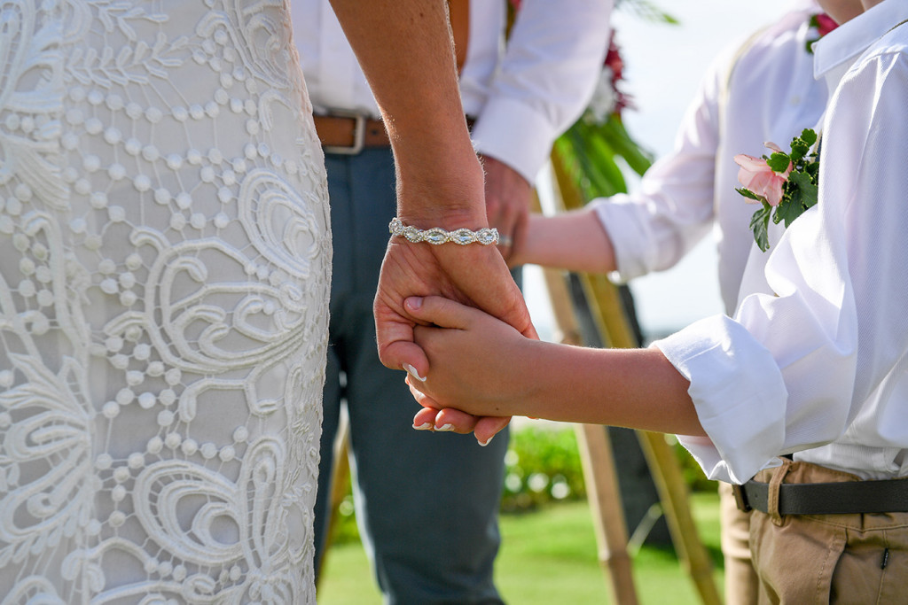 Closeup as Bride holds her son's hand