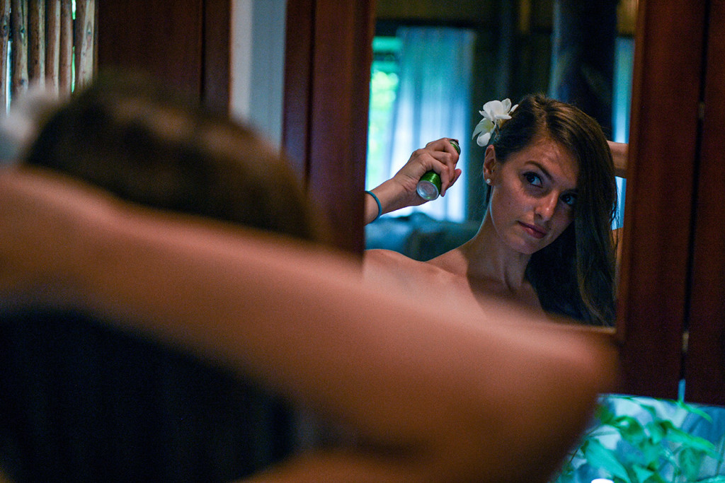 The bride is getting ready and looking at herself in the mirror