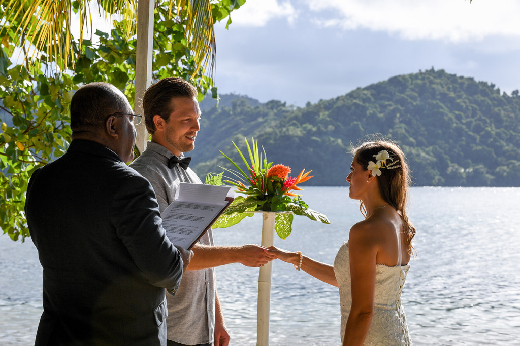 Groom is holding the bride's hand wedding ceremony, Matangi island in Fiji