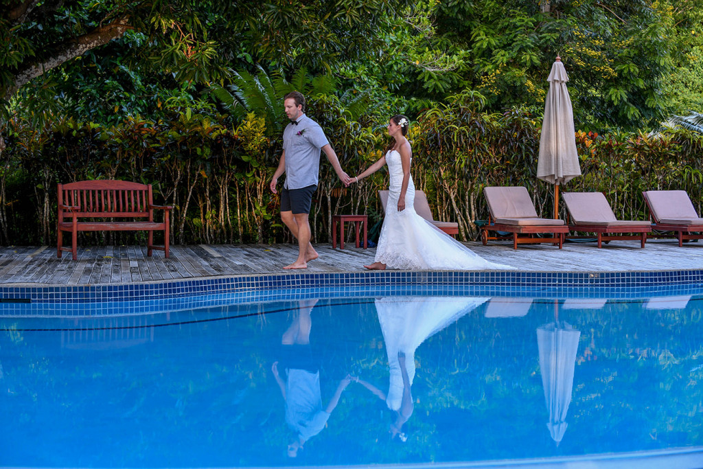 Bride and groom by the swimming-pool at Matangi island resort in Fiji
