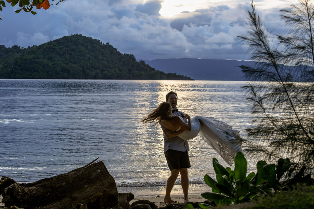 Groom carrying the bride, Matangi island resort in Fiji