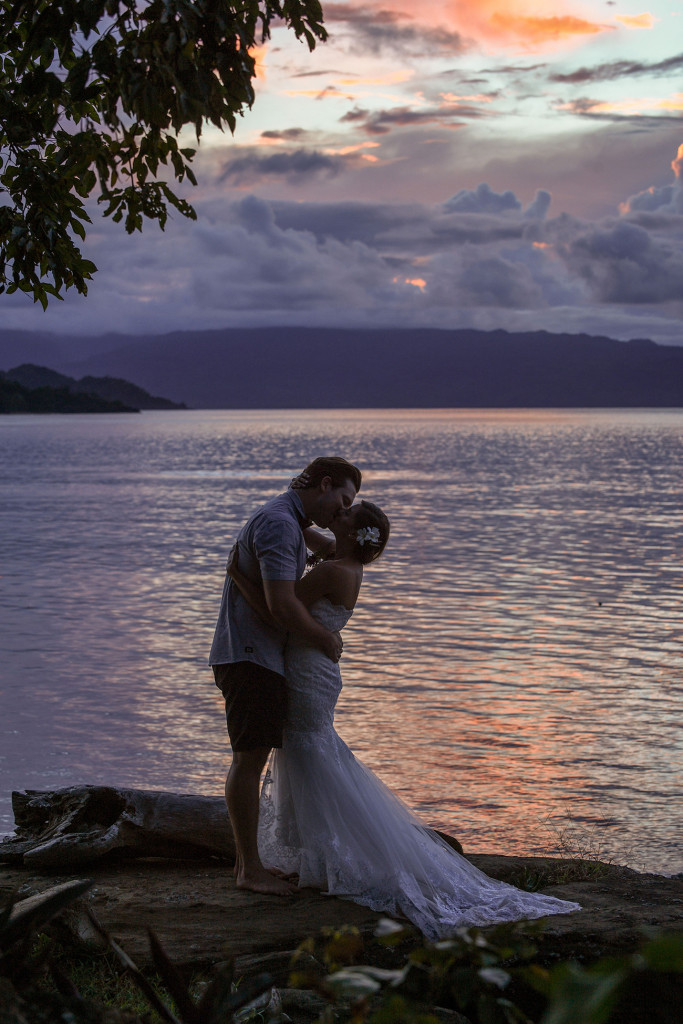 Married couple kissing at Sunset, Matangi Island resort, Fiji