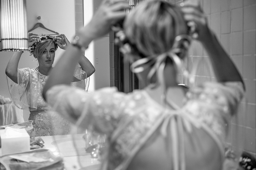 Reflection of the bride adjusting her flower crown