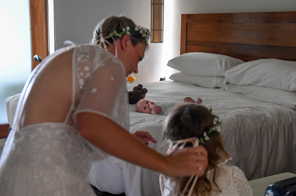 Bride adjusts the flower crown on her flowergirl