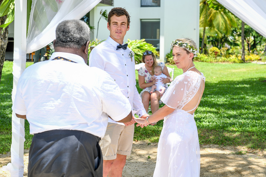 Bride and groom exchange their vows in elopement wedding at Hilton Denarau Fiji