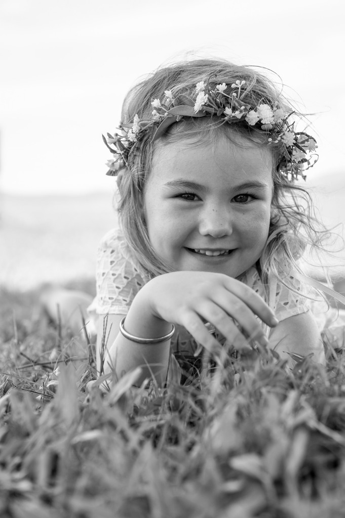 Monochrome of sweet flowergirl smiling into the camera