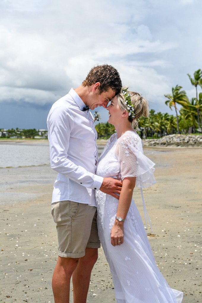 Bride and groom look into each other's eyes at the Magnificent black sand beach Fiji