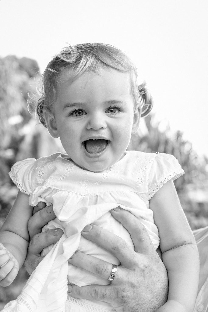 Monochrome photo of cute smiling flower girl