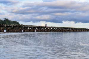 Landscape photo of married couple on a bridge against clouds in Naviti Fiji