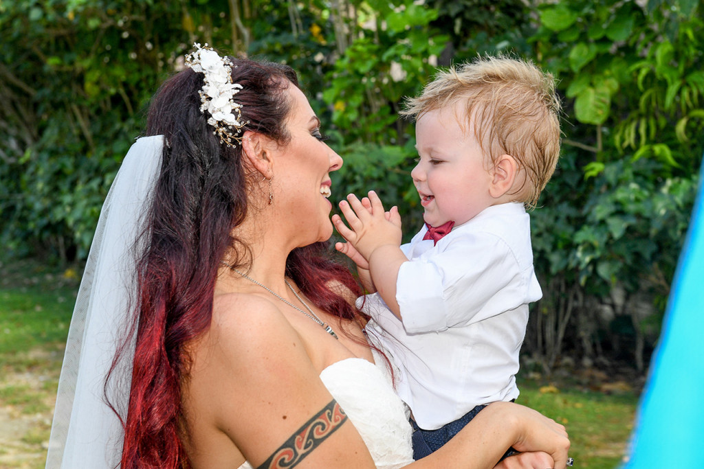 Bride laughs with her son on her wedding ceremony