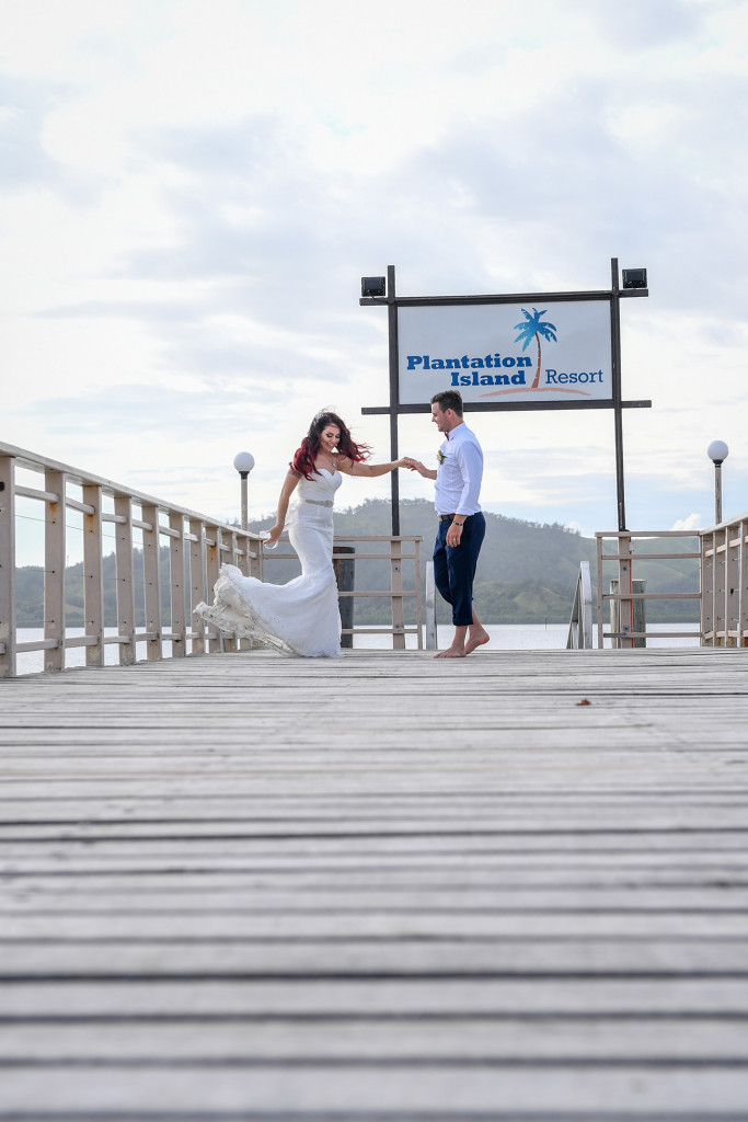 The bride dances on the dock with her husband at the Plantation Island Resort