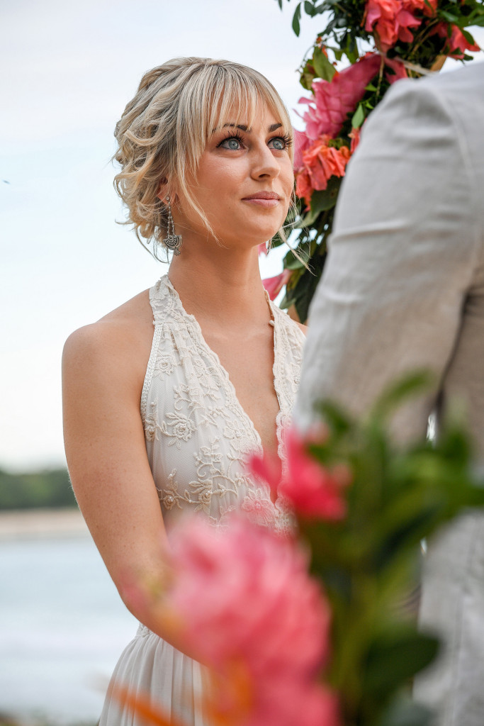 Stunning blue eyed bride stares lovingly into her groom's eyes