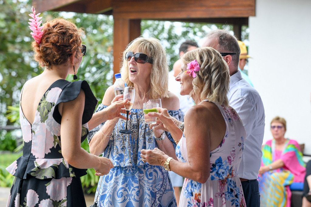 Guests mingle and enjoy drinks at the Maui bay Airbnb wedding