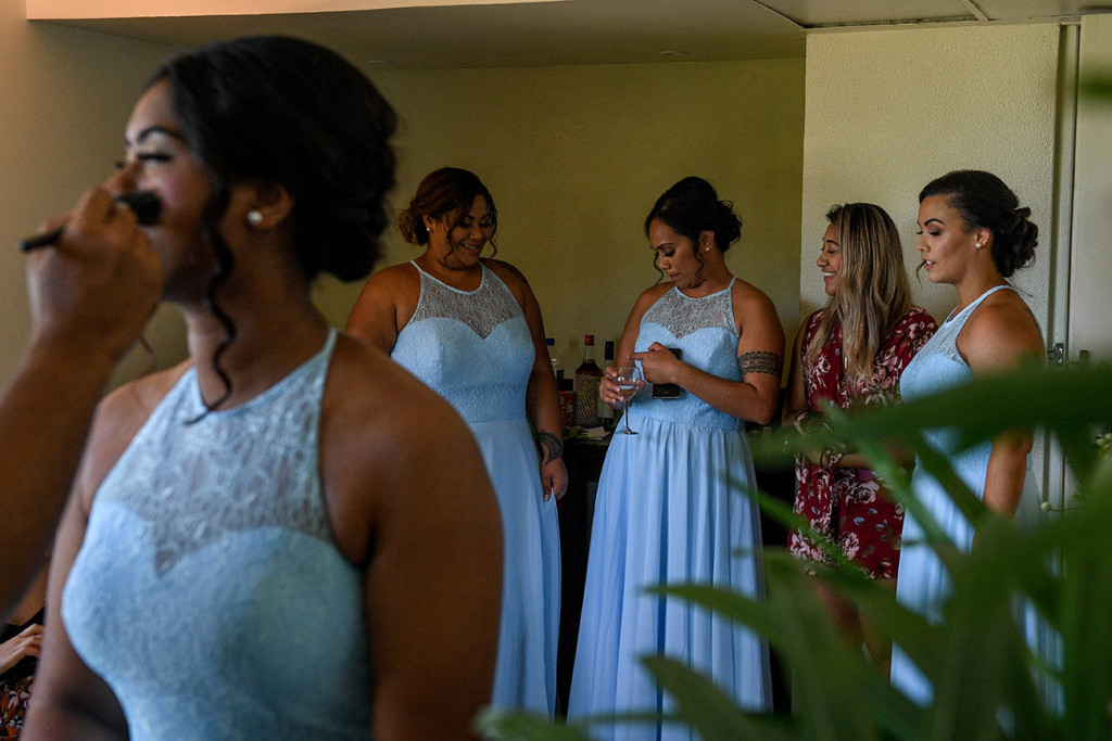 Bridesmaids chat, laugh and drink during wedding preperations