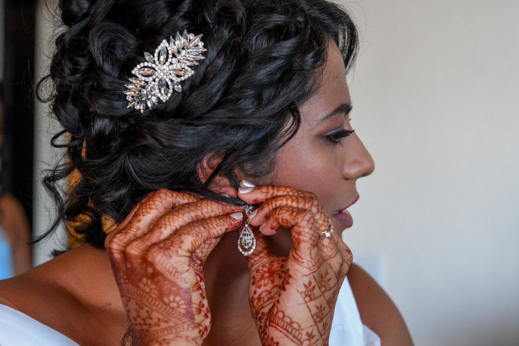 A closeup of the bride's hennaed hands wearing her wedding jewellery