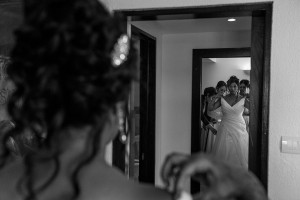 Monochrome photo of the bride admiring her dress by Elegance Marriage in the mirror