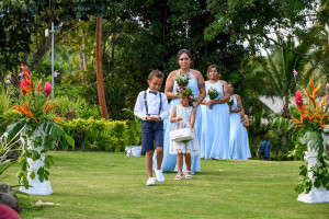 Flowergirl, page boy and bridesmaids lead the way down the aisle