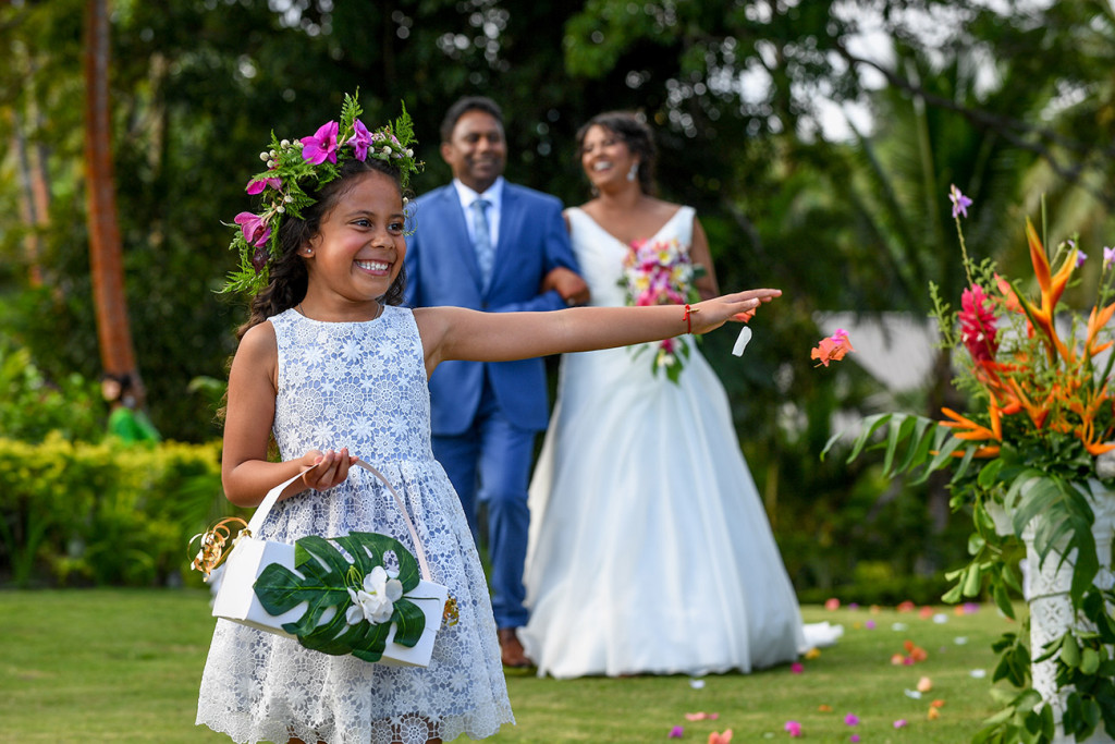 Cute and happy flowergirl walks before the bride