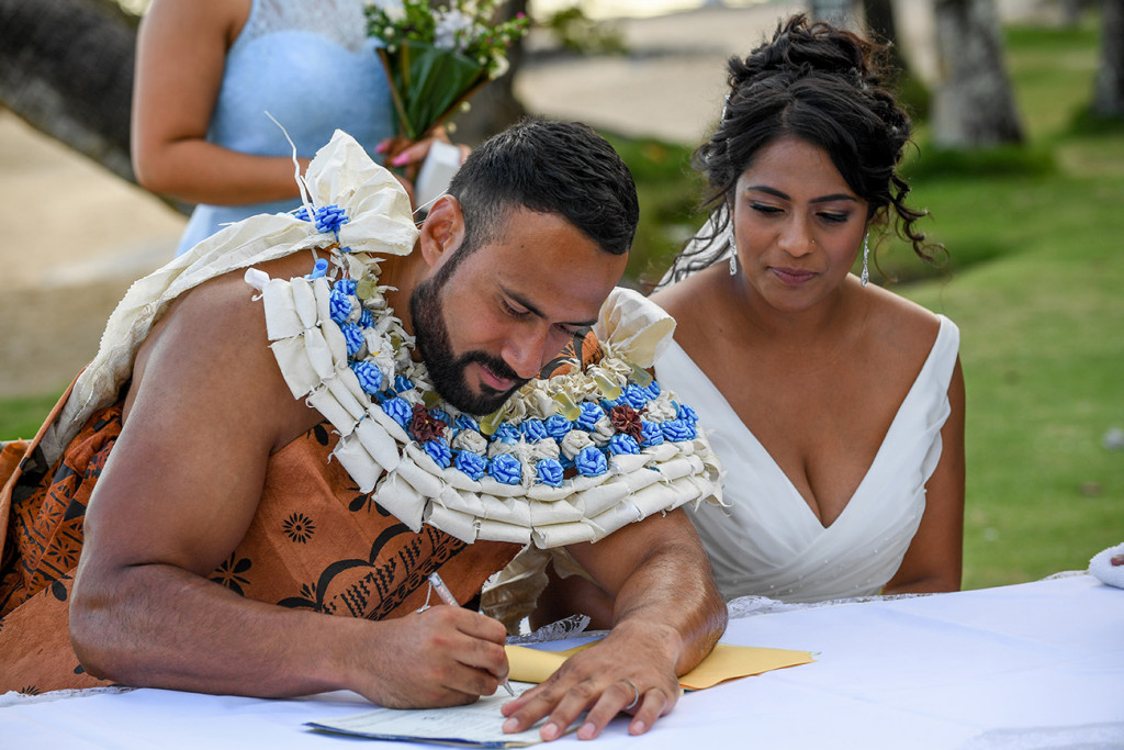 The groom signs the marriage certificate