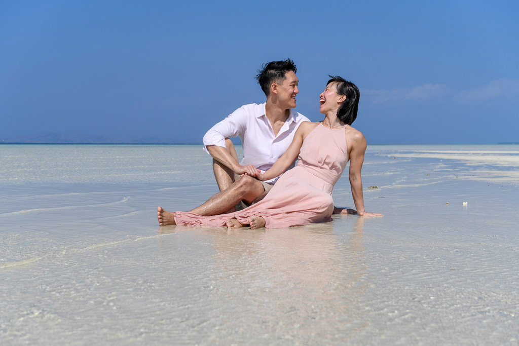 The couple laugh when seated in the shallow waters at Malolo Lai Island