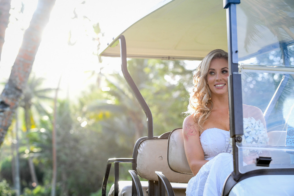 The glowing bride arrives in a golf cart