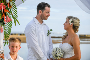 The groom lovingly looks into his bride's eye as he says his vows