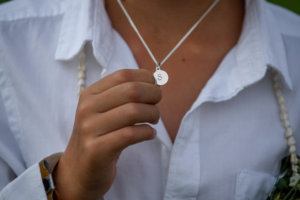S necklace; groom wears S shaped necklace named after his wife