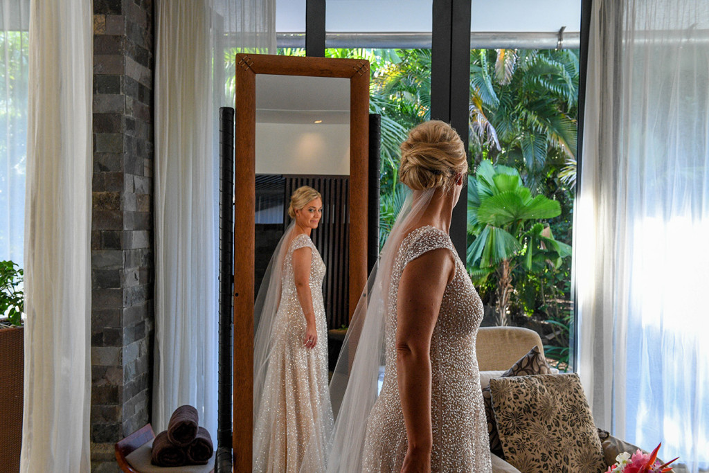 Bride admires her full length reflection in the mirror