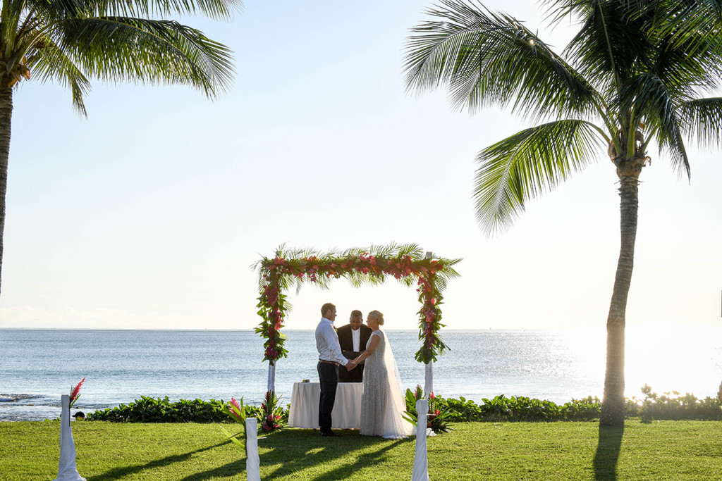 Picture perfect portrait of the couple saying vows against the Pacific ocean