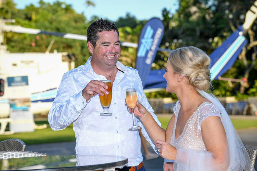 The happily married couple share a cheeky drink after their ceremony