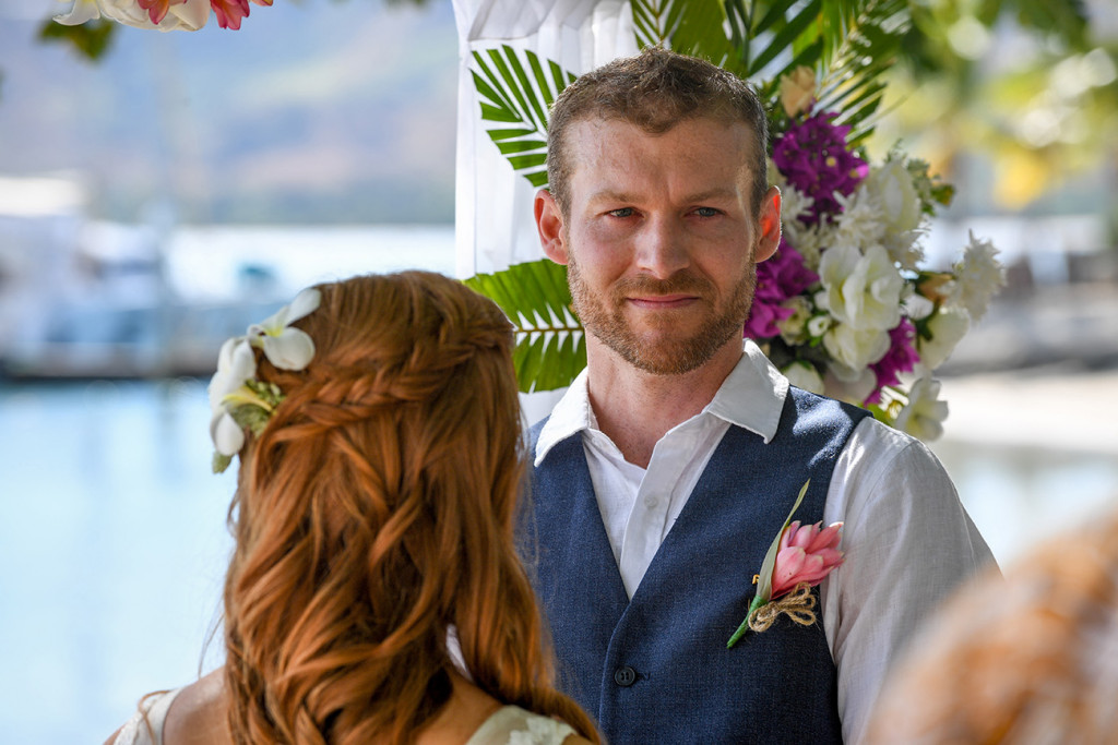 The emotional groom looks at his wedding guests when giving his vows