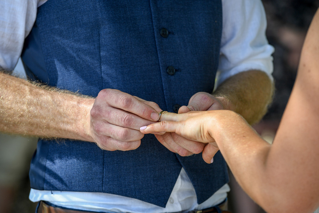 Closeup of the groom slipping the ring onto his bride's finger at Musket Cove Fiji