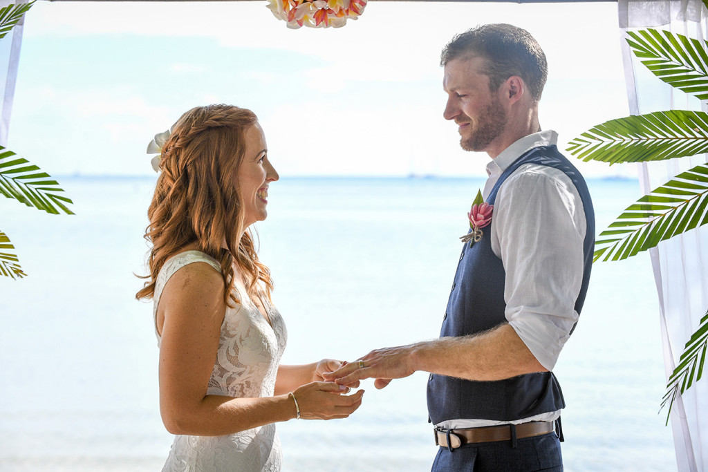 A stunning portrait of the bride and groom at the altar against the Pacific ocean