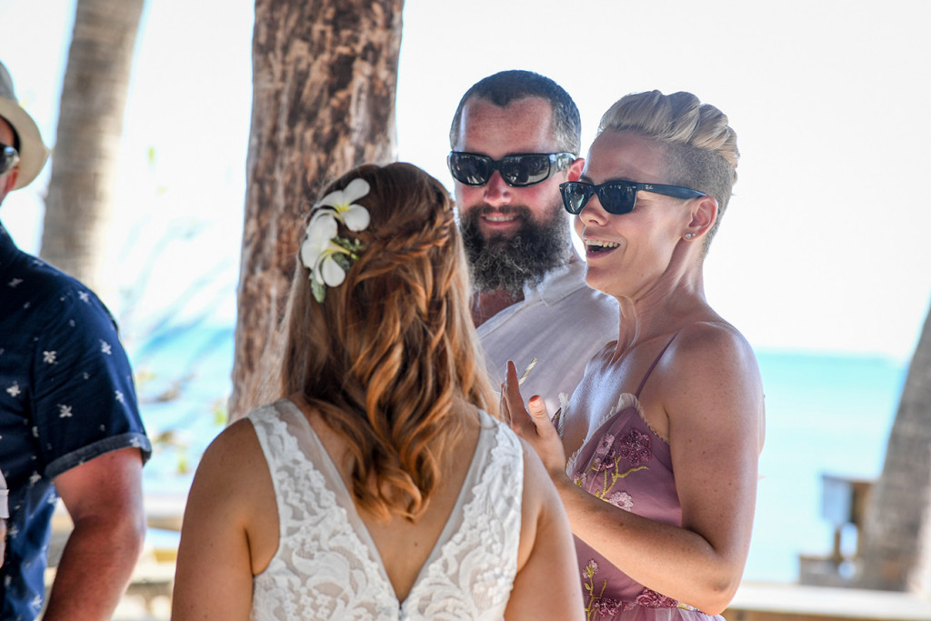 Bride chats with modern and cool looking guests at the island bar