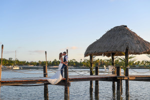 Bride and groom share a passionate kiss on the docks of Musket Cover Fiji
