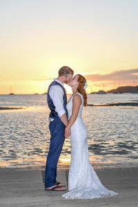 The couple passionately kiss behind a golden sunset at Musket Cove Fiji