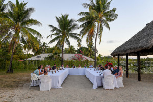 Wedding reception setup under moonlight and palm trees at Musket Cove Fiji