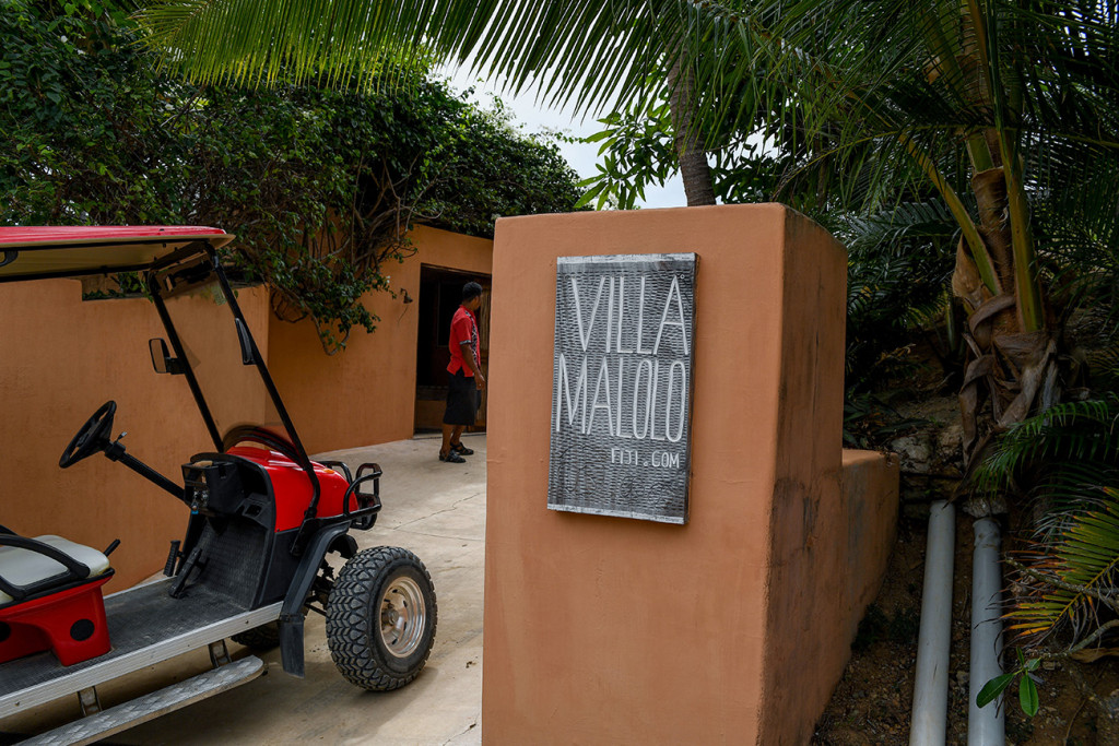 Red golf cart parked at the door of the Villa Maloo entrance
